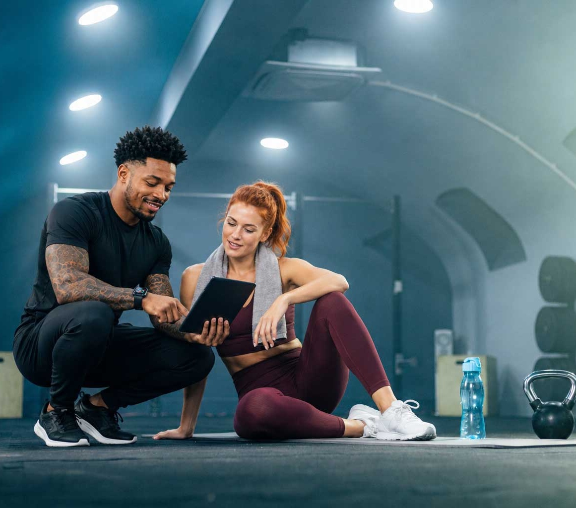 Coach and client reviewing CORE by fibodo on a tablet