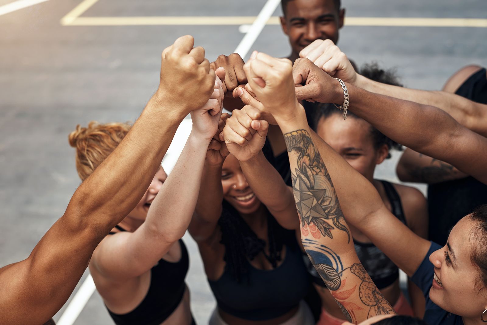 Team celebrating together with hands raised
